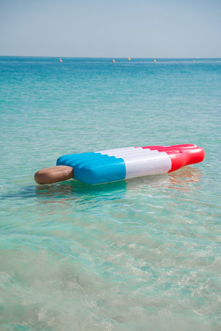 Red And White Inflatable Floater On Water