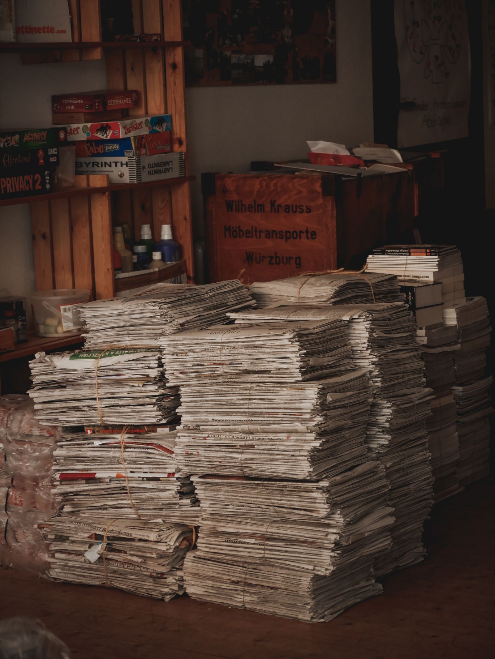 Stacks of newspapers piled on a floor, ready for recycling