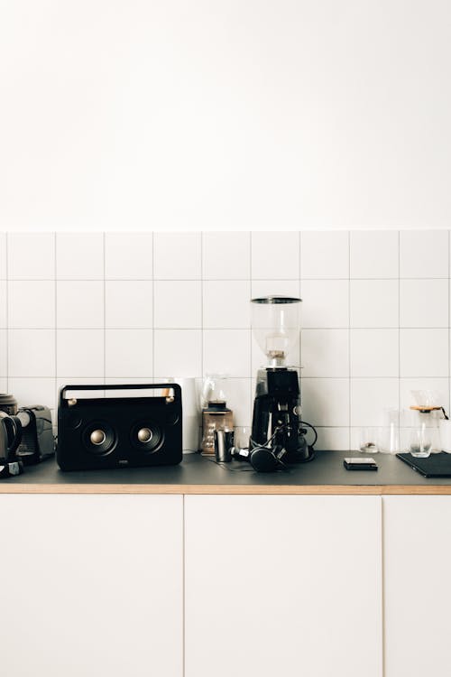 Free A Coffee Maker Beside Black Speaker on Kitchen Table Top Stock Photo