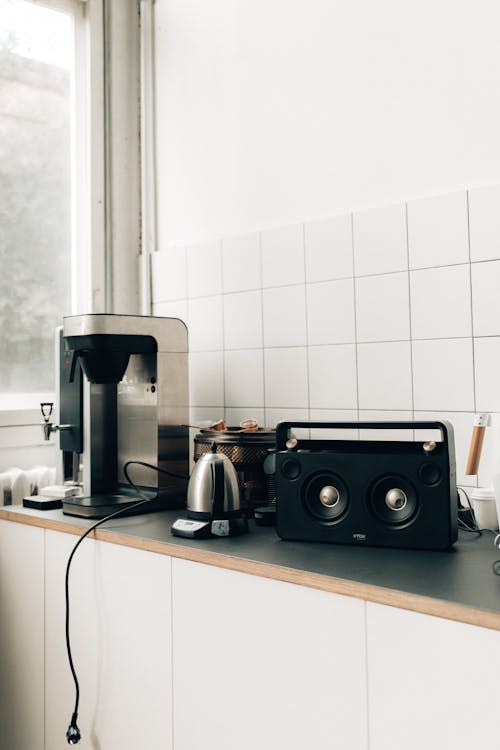 Free Black and Silver Coffee Maker Beside White Ceramic Wall Tiles Stock Photo