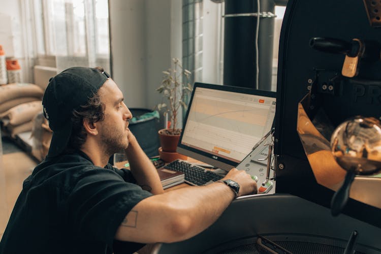 Man In Black T-shirt Using Black Computer