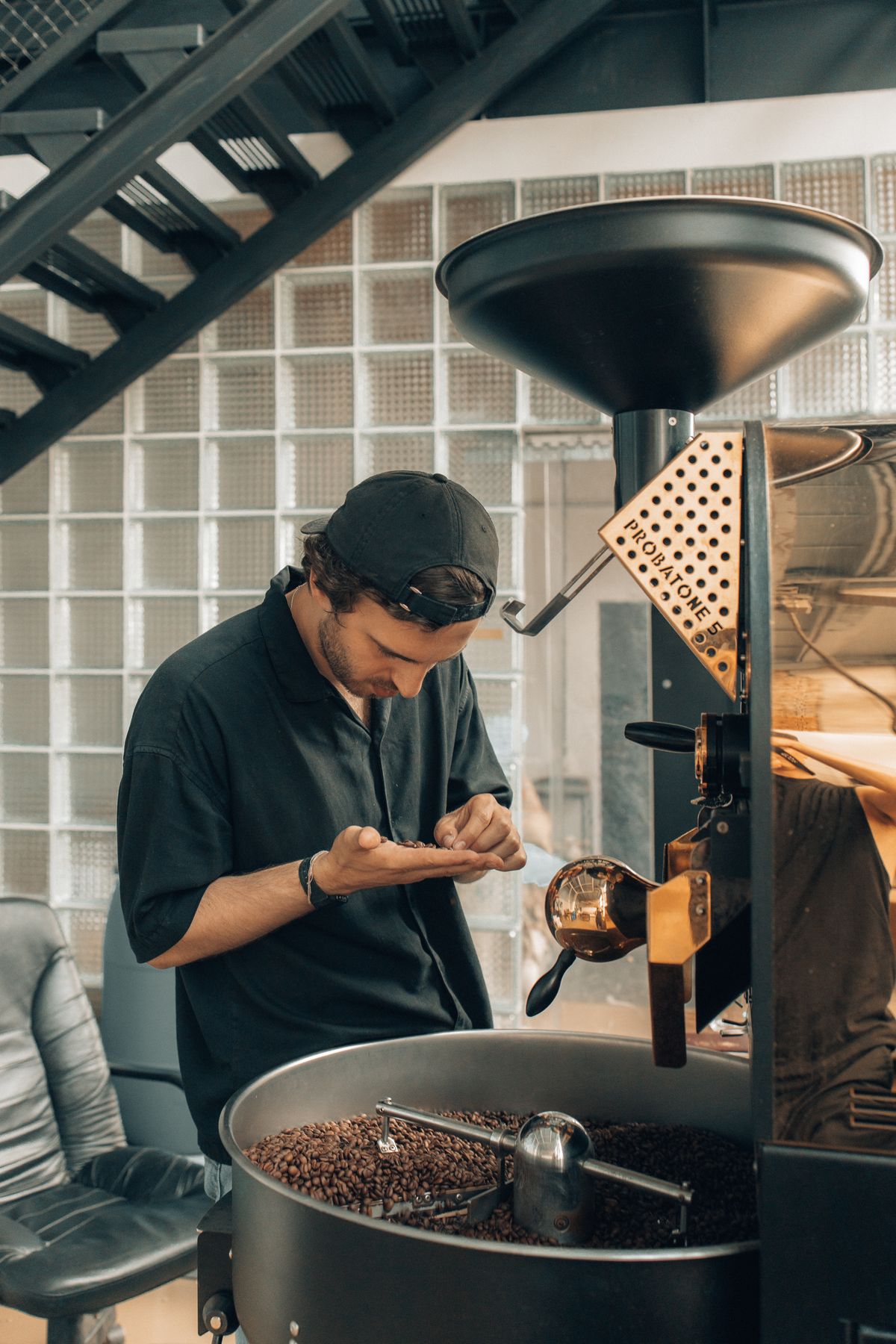 Examining coffee beans during roasting, for illustration