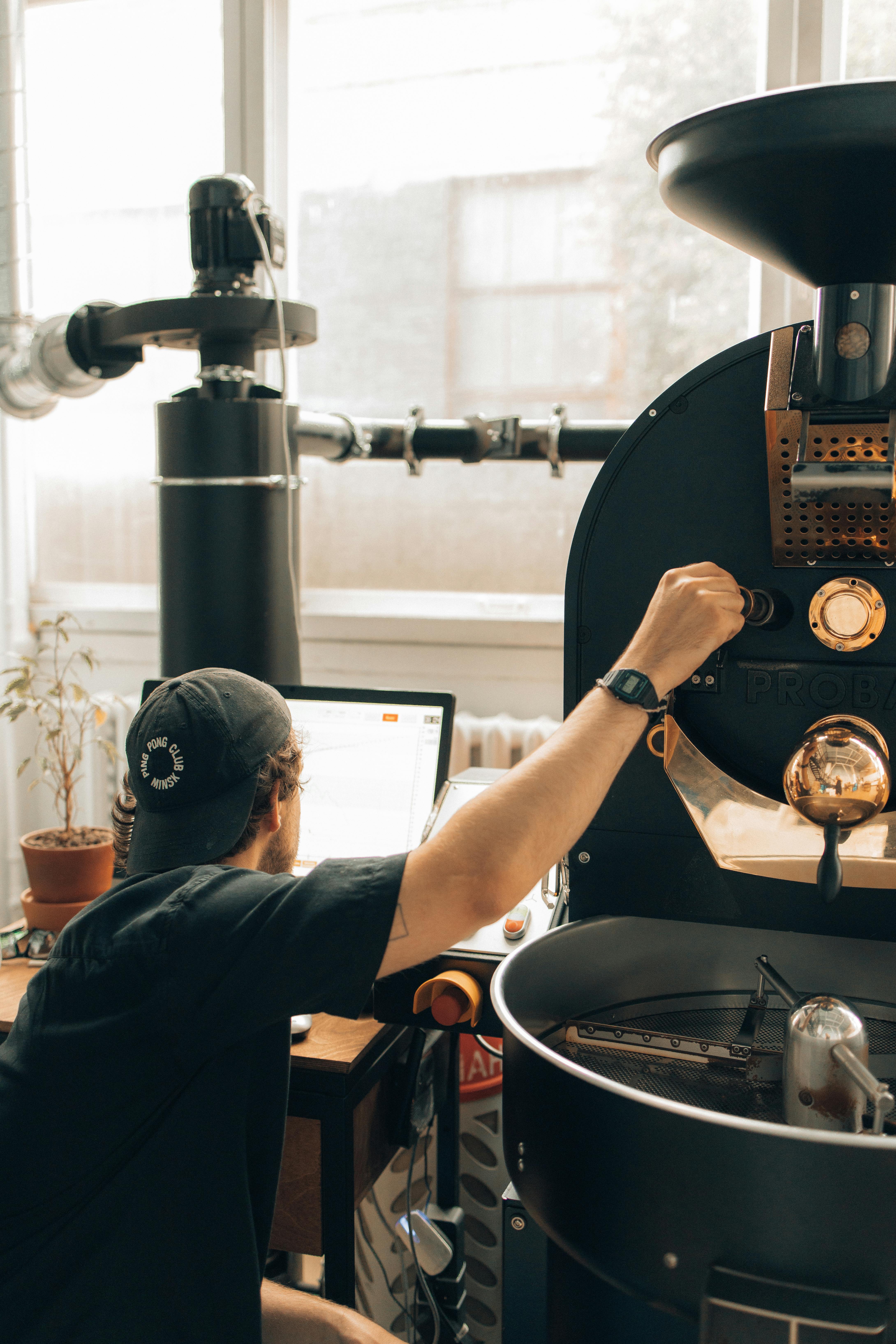 man operating a machine at a coffee roasting factory