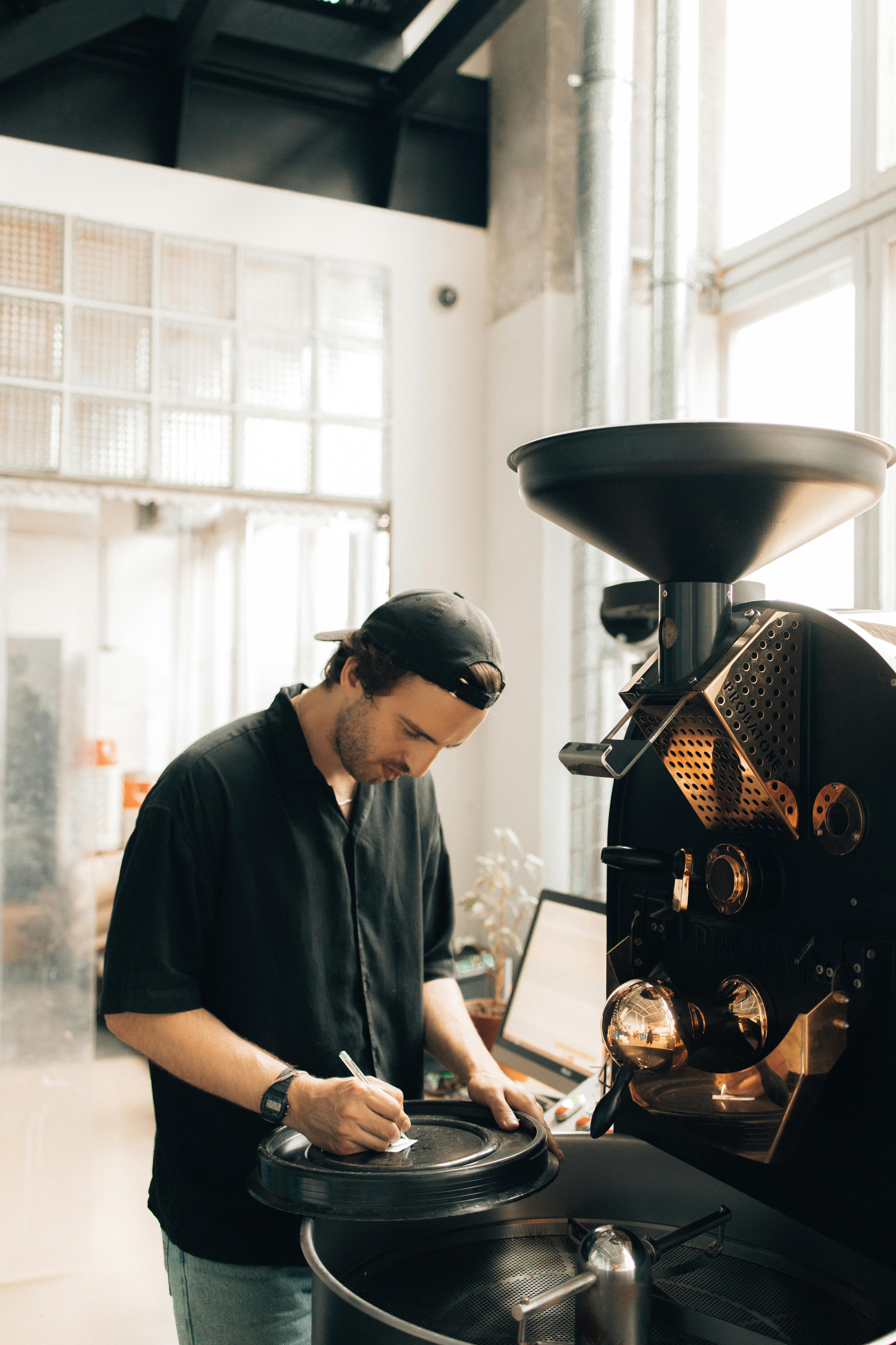 man operating a machine at a coffee roasting factory