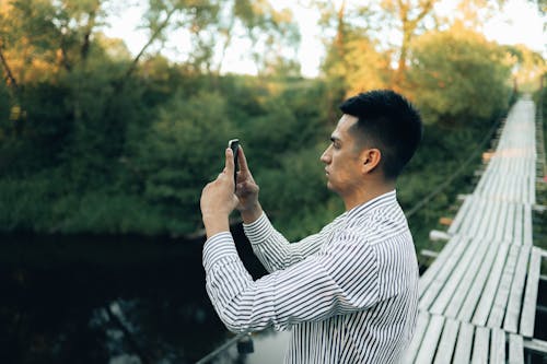A Man Taking Photo Using His Smartphone