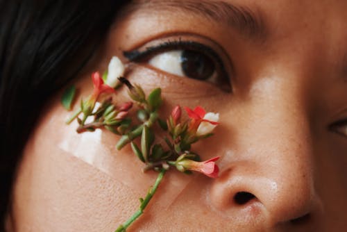 Woman With Red and White Flower on Her Face