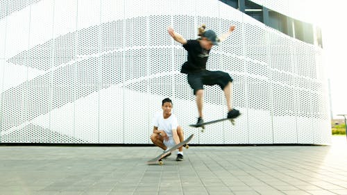 Two Men Using Skateboard