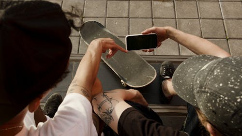 Free Person in White Shirt and Black Shorts Holding Iphone 6 Stock Photo