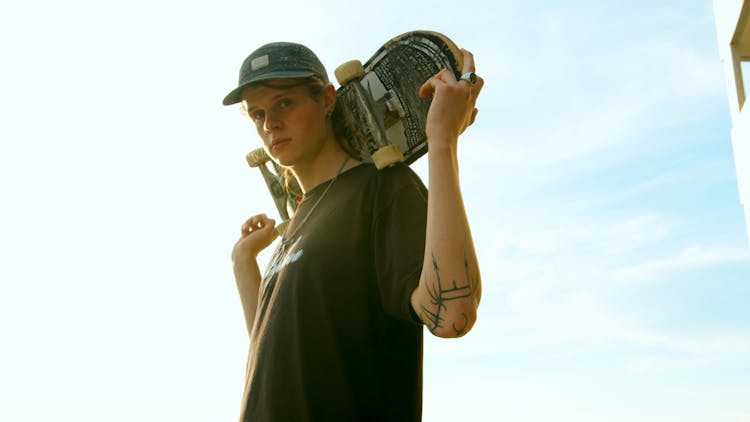 Photo Of Man Carrying A Skateboard