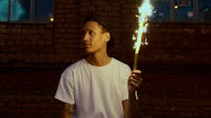 Man in White Crew Neck T-shirt Holding Fire