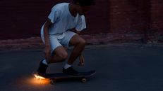Man in White T-shirt and White Shorts Sitting on Skateboard