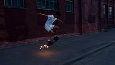 Man in White T-shirt and Blue Shorts Jumping on Road