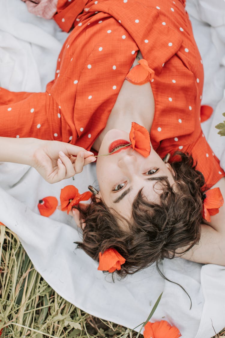 Woman Biting Red Poppy Flower