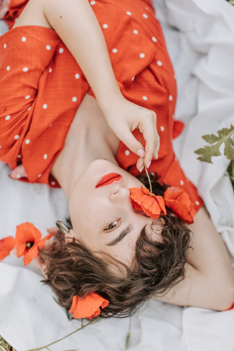 Woman Holding A Red Poppy