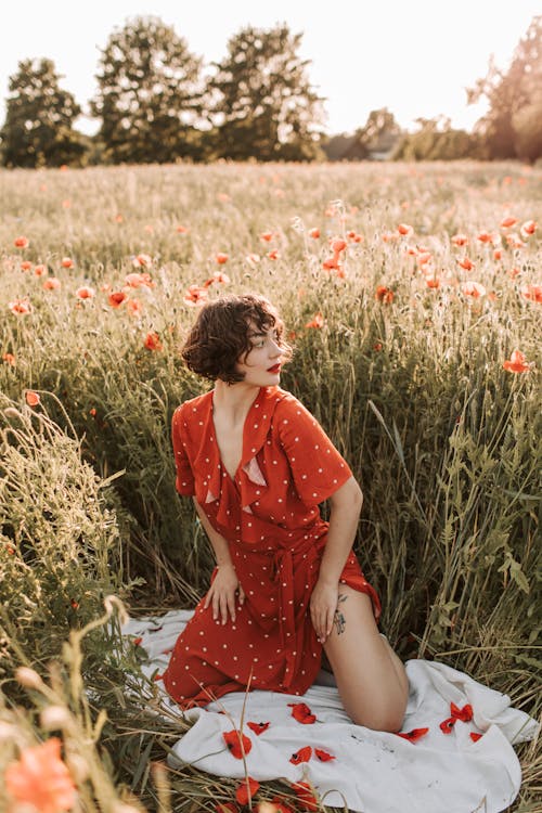 A Woman Kneeling on the Poppy Flower Field