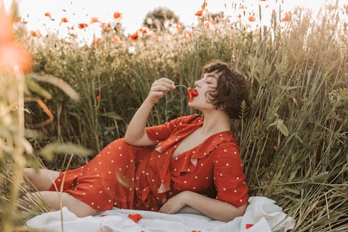 A Woman Putting Flower to her Mouth