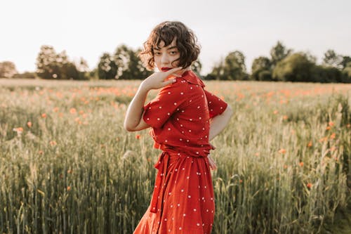 Woman in Red Polka Dots Dress Standing in the Field