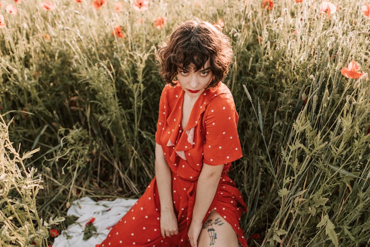 Woman In A Polka Dot Dress Posing Near Grass