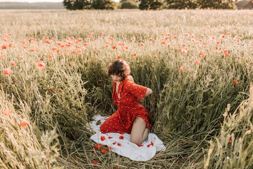 Woman Kneeling on a White Blanket