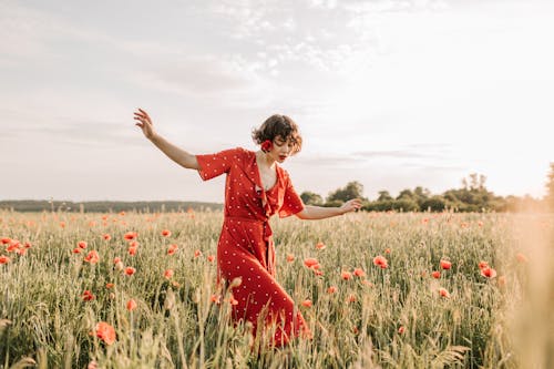 Woman Wearing Red Dress Walking in the Field