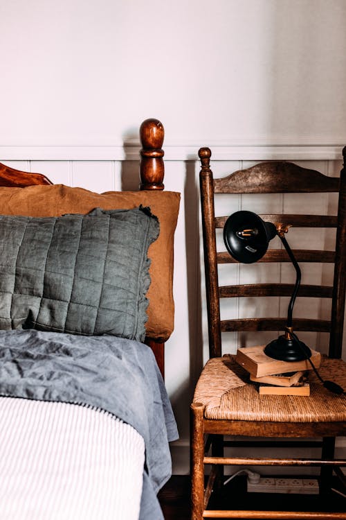 Free Black Desk Lamp on Top of the Chair Near Bed  Stock Photo