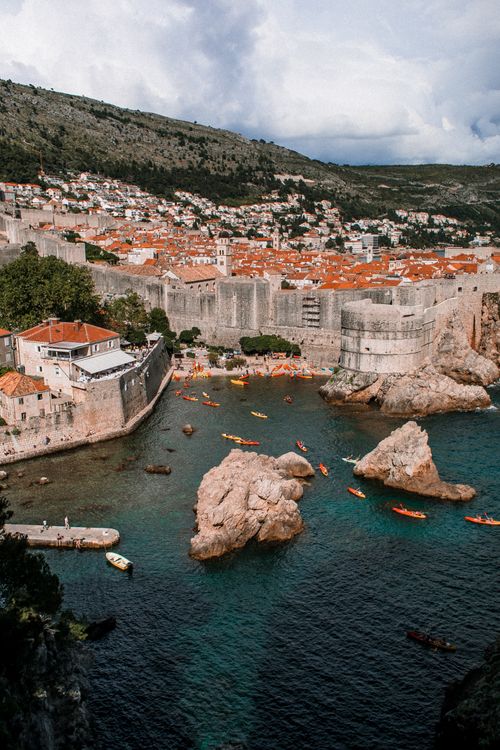 Free A captivating aerial shot of Dubrovnik, showcasing the iconic city walls and clear blue sea. Stock Photo