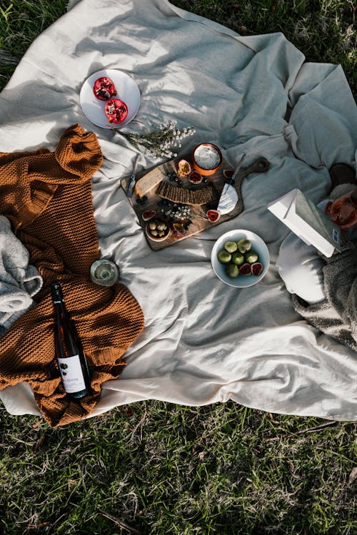 Free White Textile on Grass with Wine and Food  Stock Photo