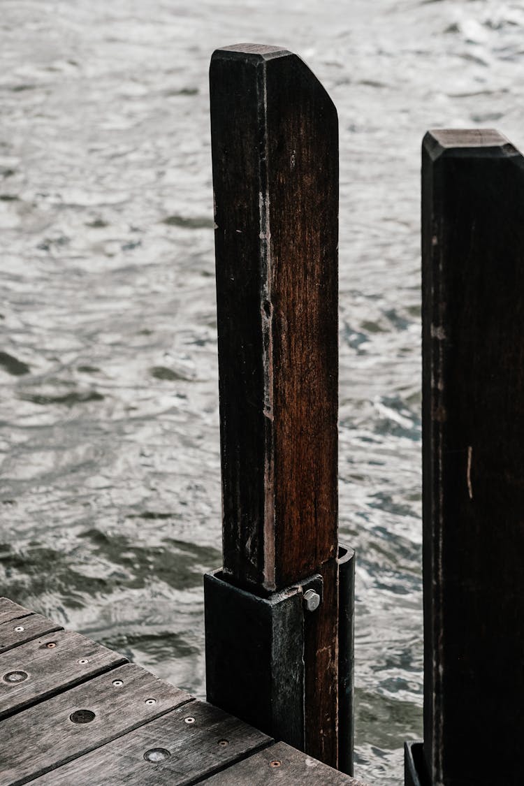 Wooden Post Near Body Of Water 