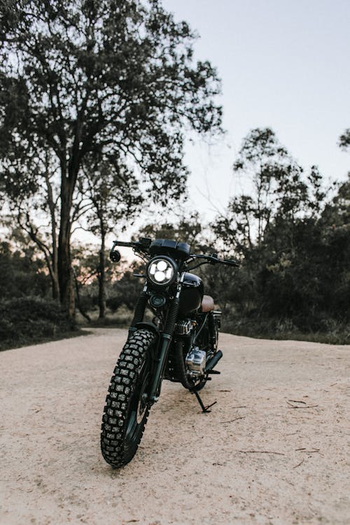 Black Motorcycle Parked on Brown Sand