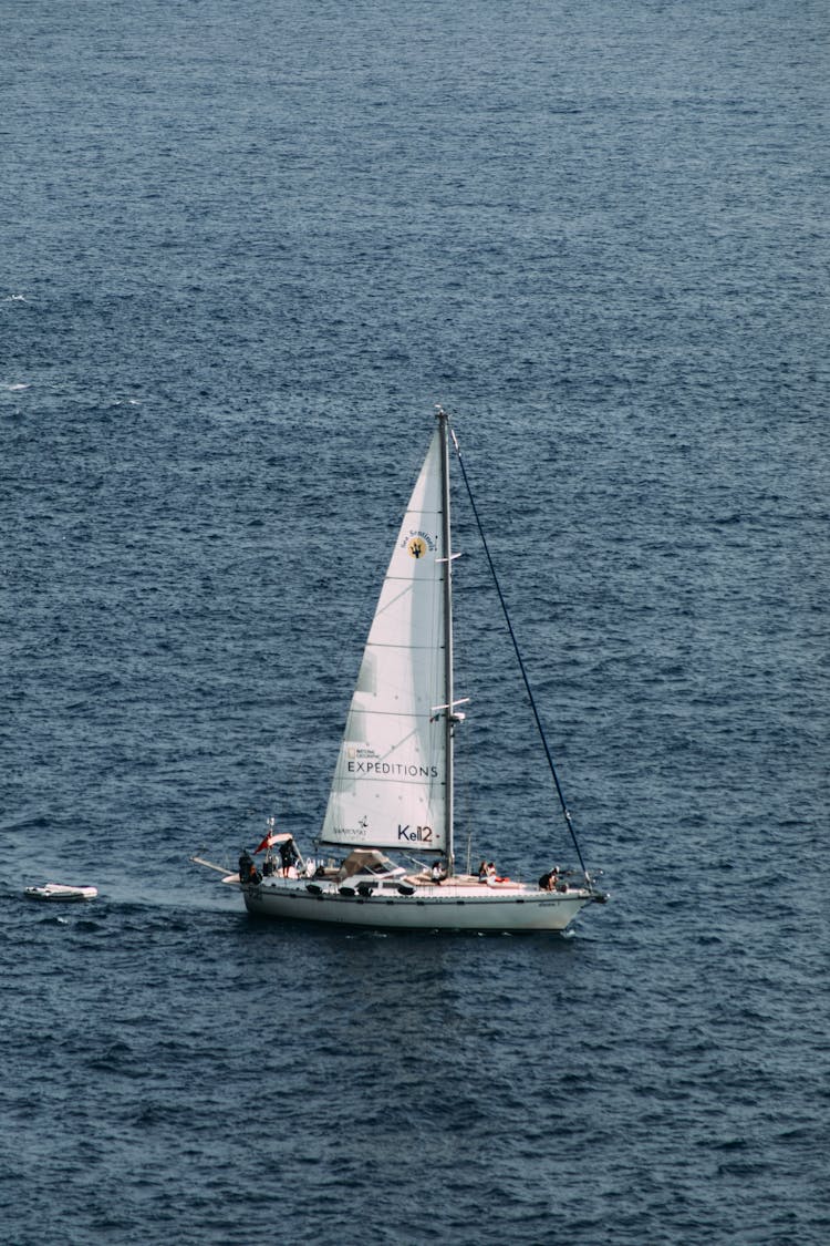 Small Sailboat Floating In Sea