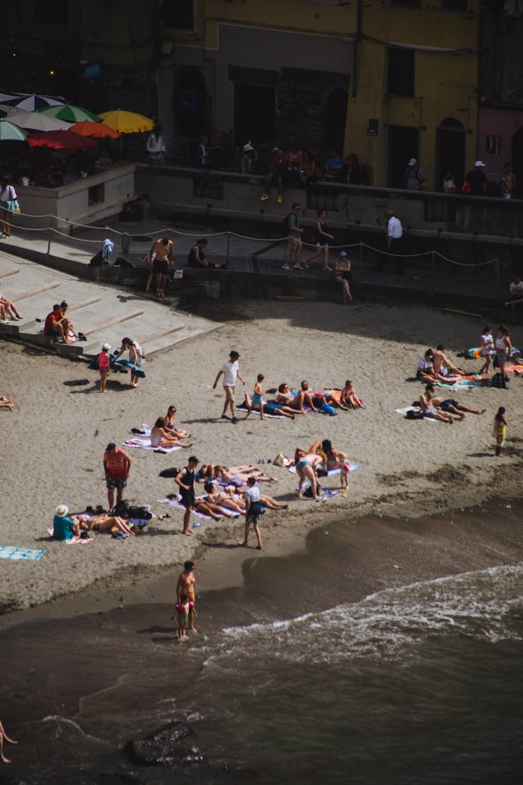 People Resting On Sandy Beach