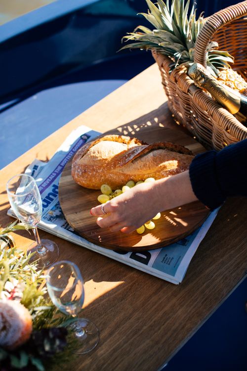 Free From above of crop anonymous female setting table with fresh fruits and food for picnic Stock Photo