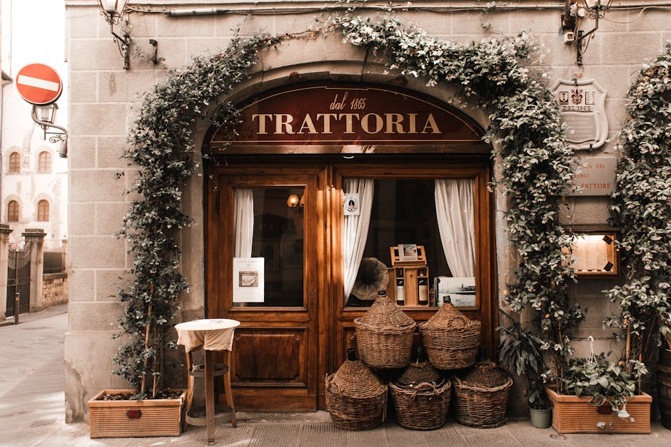 Exterior of cozy Italian restaurant with wooden door and entrance decorated with plants