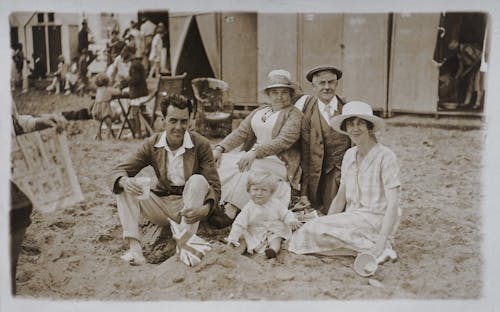 Free Photo Of Family Sitting On Beach Sand Stock Photo