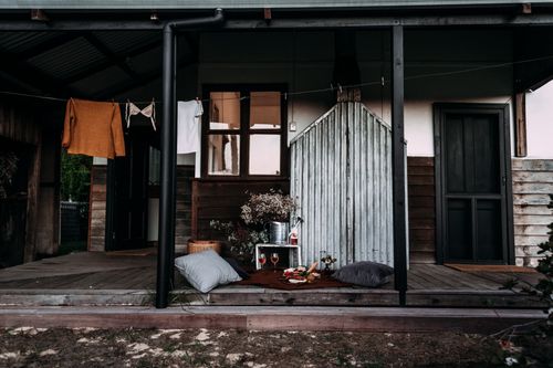 Free Shabby empty wooden terrace of residential house in countryside after romantic picnic on pillows Stock Photo
