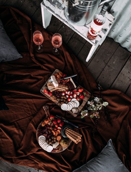 Free Top view of trays with sweets berries and cookies and glasses of wine on plaid prepared for romantic date Stock Photo