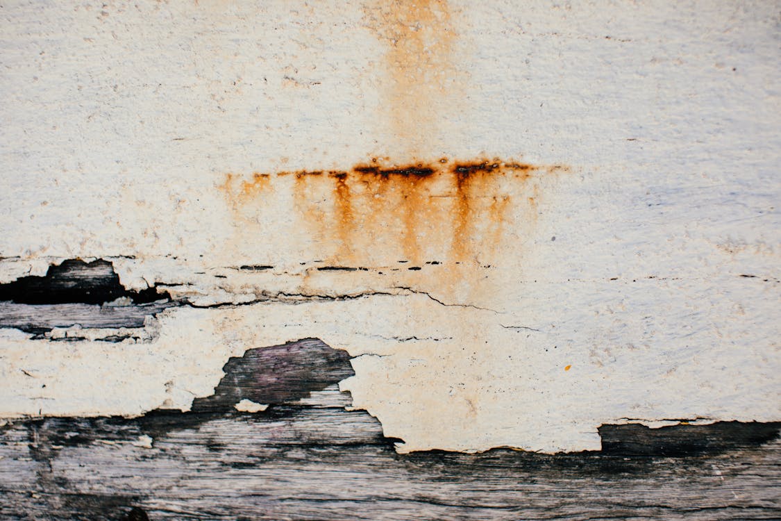Textured background of weathered shabby cracked aged surface of old wall with plaster
