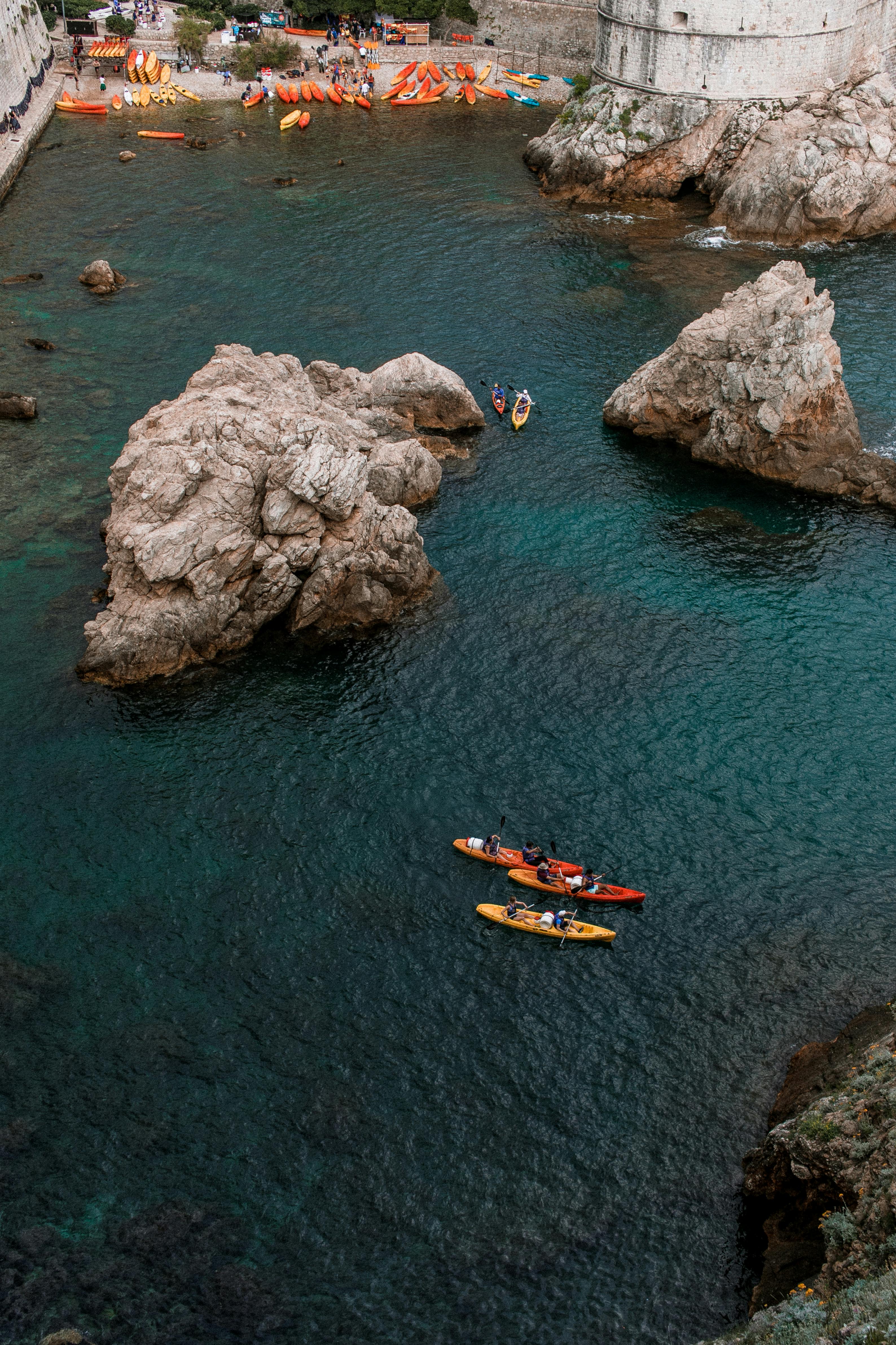 Sea with kayaks in Dubrovnik surrounded with Old Town and beach