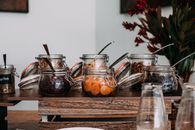 Assorted dried fruits and nuts in transparent jars on table
