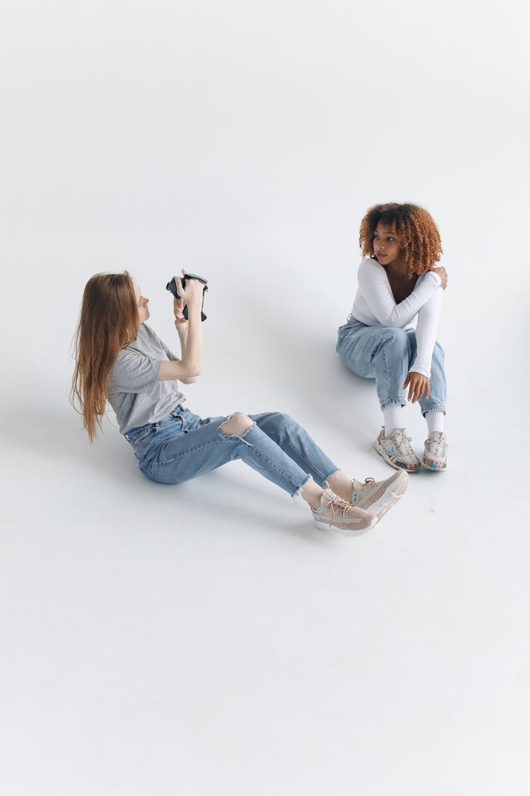 Women Sitting On White Floor