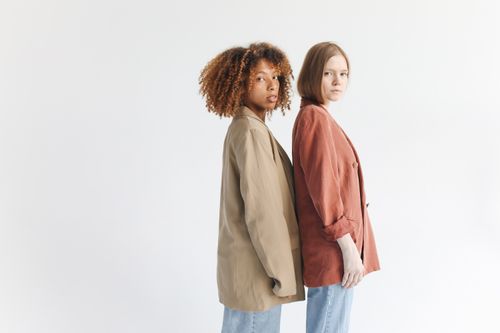 Free Portrait of two diverse women in stylish jackets showcasing modern fashion trends. Stock Photo