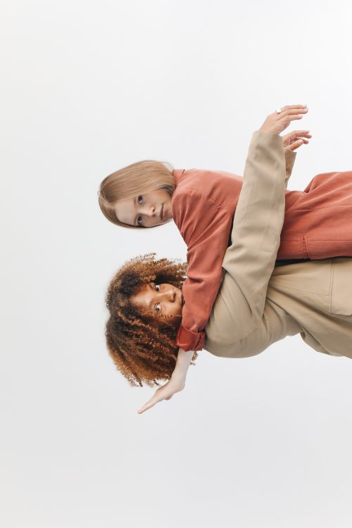 Free Creative portrait of two diverse women in stylish outfits, showcasing friendship and expression. Stock Photo