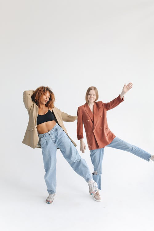Studio Shot of Two Models in Jeans and Blazers