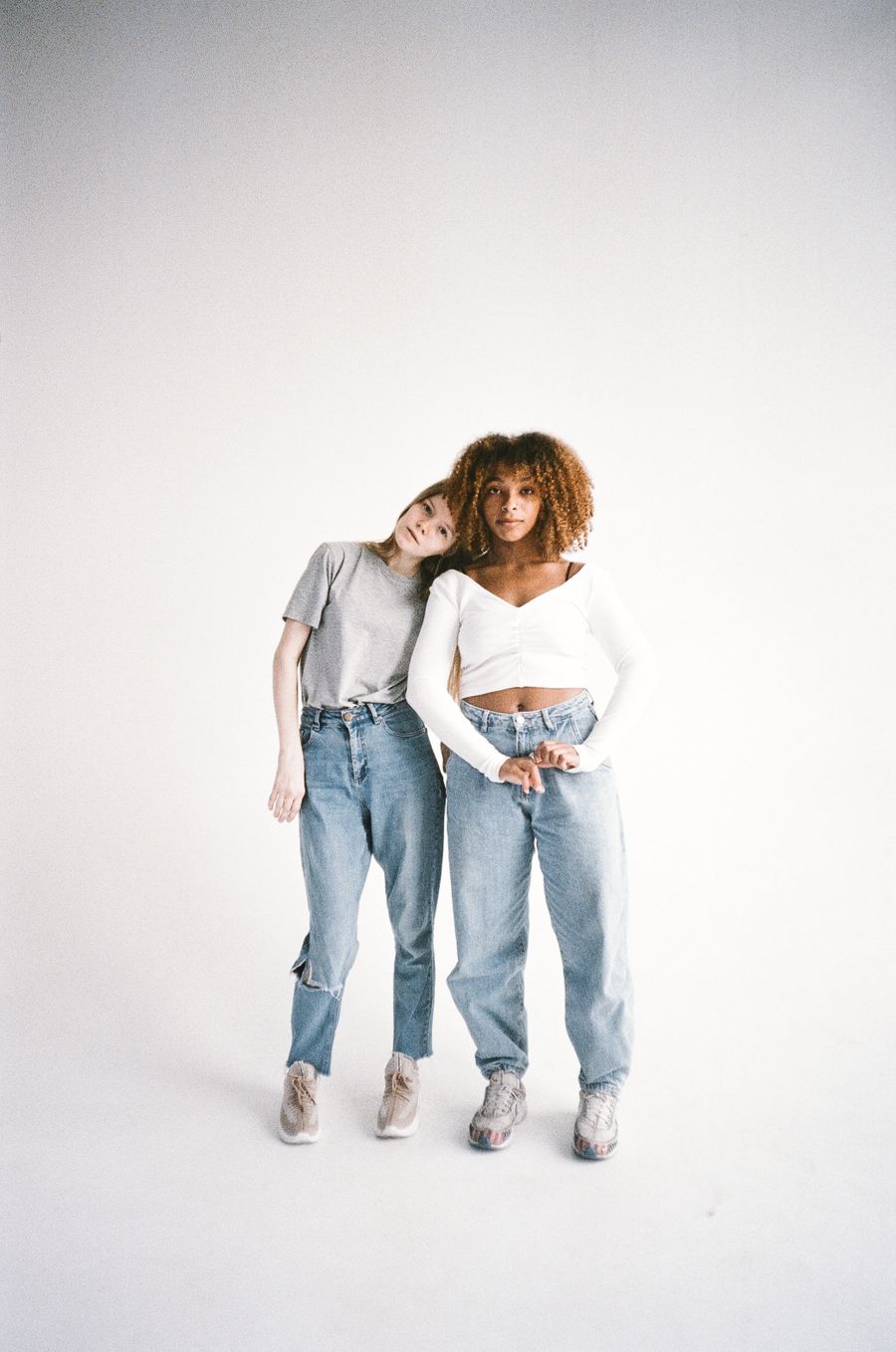 Two friends in casual denim standing together — photo by Polina Tankilevitch on Pexels