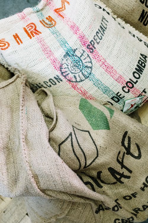 Free Close-up of burlap sacks for organic coffee beans in a roastery setting. Stock Photo