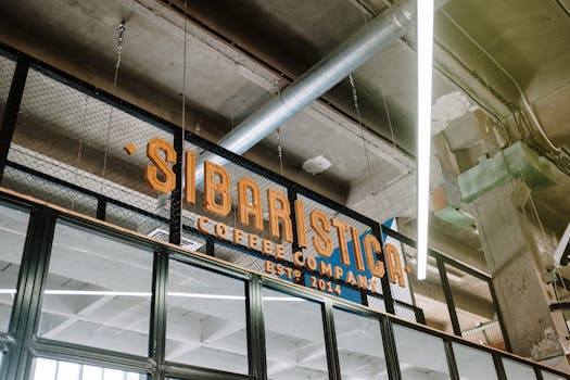 Interior of an industrial loft featuring Sibaristica coffee company sign.
