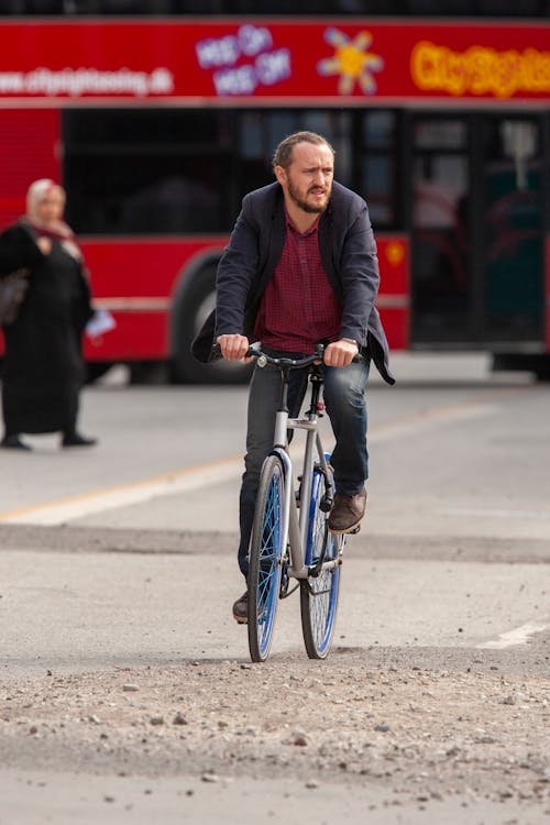 Man Riding Bicycle on Road