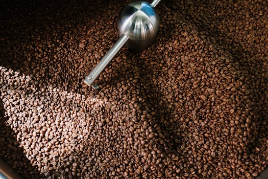 Detailed image of roasted coffee beans spinning inside a professional coffee roaster.