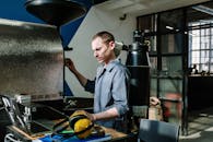 Man in Gray Dress Shirt Sitting Beside Table