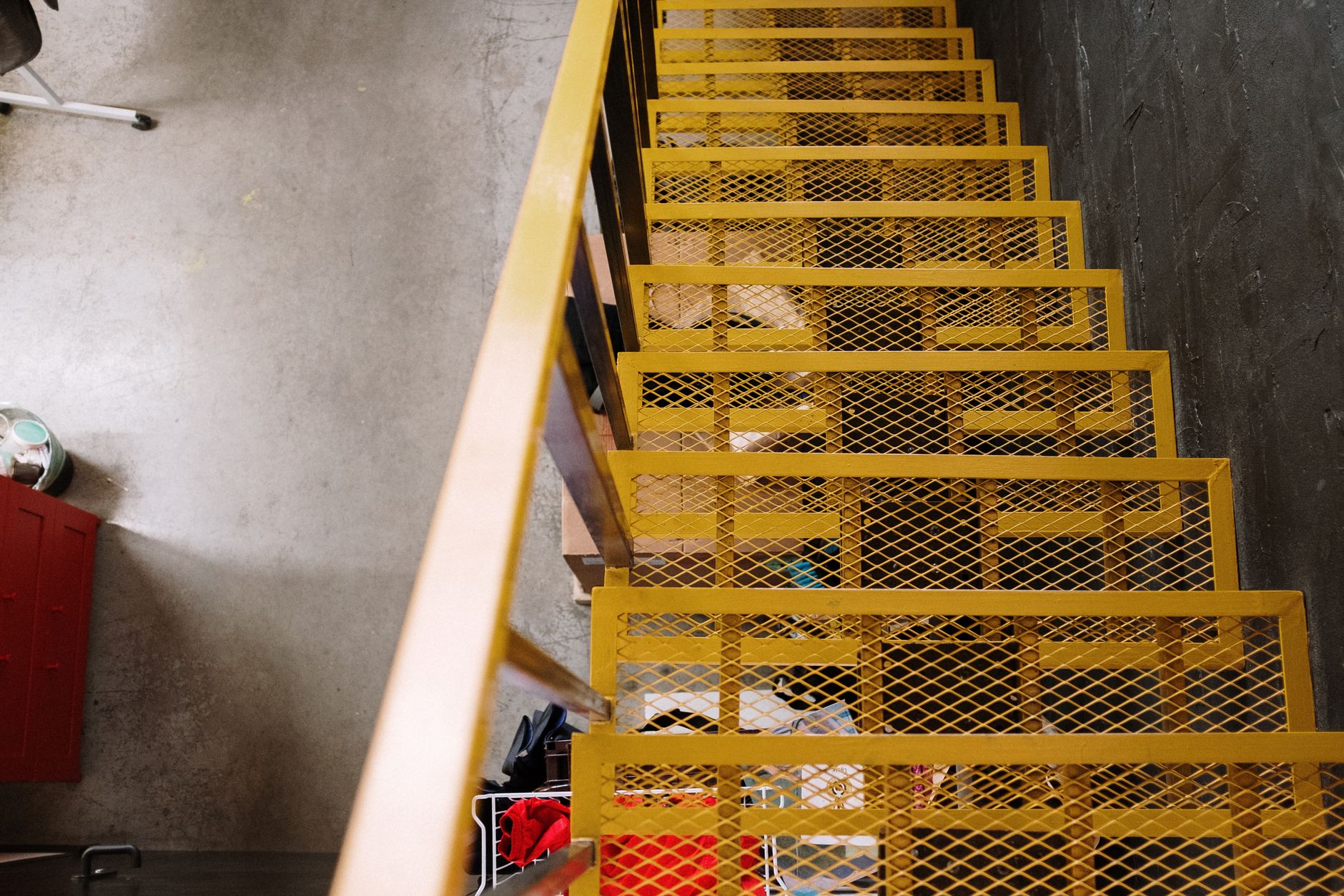 Bright yellow metal staircase adds a bold touch to this industrial loft space.. pexels, bright, yellow
